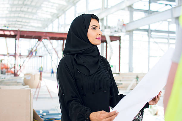 Let's see Female arabic manager supervising the construction site emirati culture photos stock pictures, royalty-free photos & images
