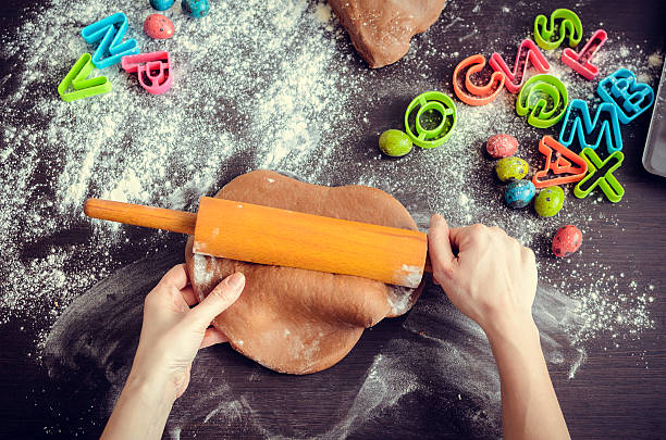 istock Woman's hands sheeting dough with rolling pin 513429156