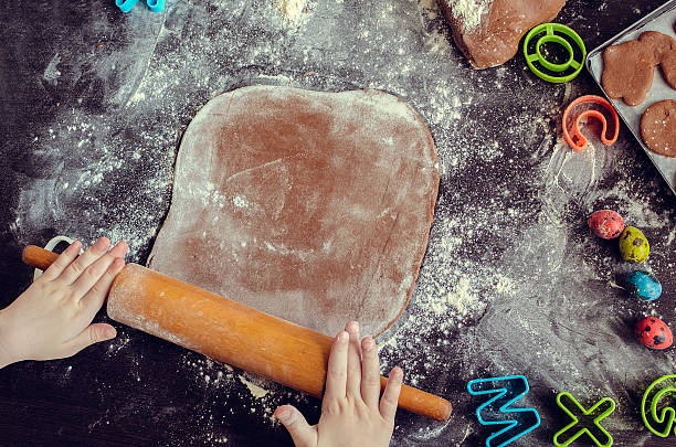 istock Young girl's hands sheeting dough with rolling pin 513429572