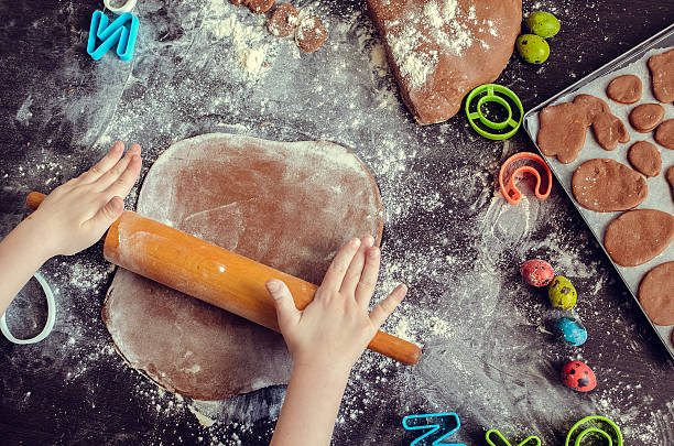 istock Young girl's hands sheeting dough with rolling pin 513429916