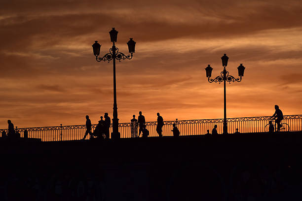 A sunset surrounding a beautiful bridge in Seville a late and warm summer evening.