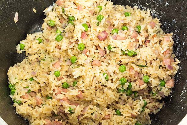 Fried Rice in Wok Closeup of combination fried rice Cooking in wok.  Overhead view. chinese cuisine fried rice asian cuisine wok stock pictures, royalty-free photos & images