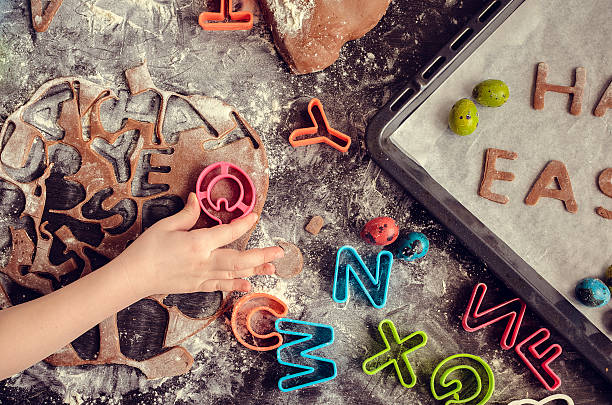 istock Little girl making easter cookies 513430394