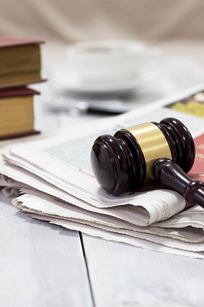 Law concept, gavel, newspaper and cup of coffee stock photo
