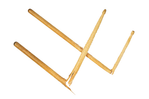 Two broken used crossed wooden drumsticks in shape of W isolated on white background