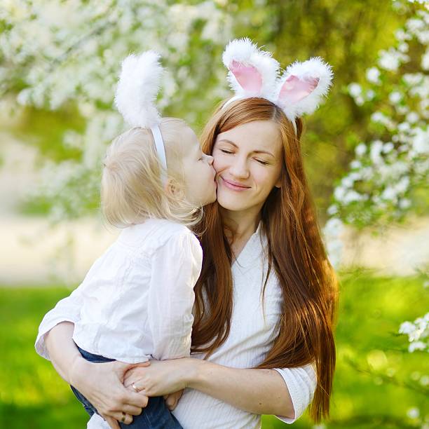 istock Mother and daughter wearing bunny ears on Easter 513434290