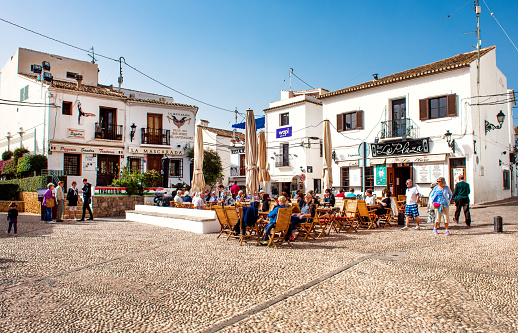 Altea, Spain- February 22, 2016: Tourists sitting in a sidewalk cafe on a main square of Altea town. Altea is a most beautiful place in the Costa Blanca. Spain