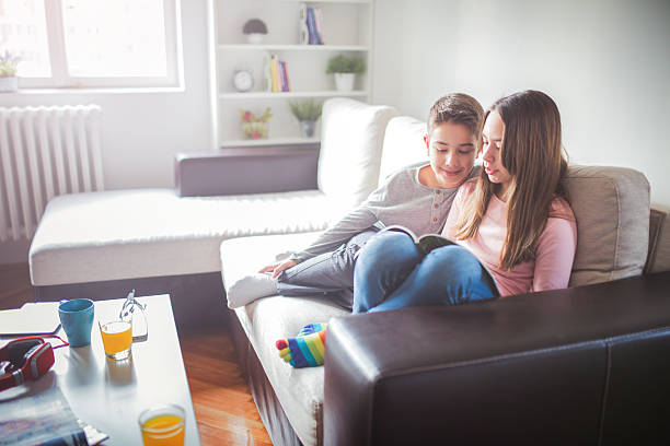 Children with magazine at home