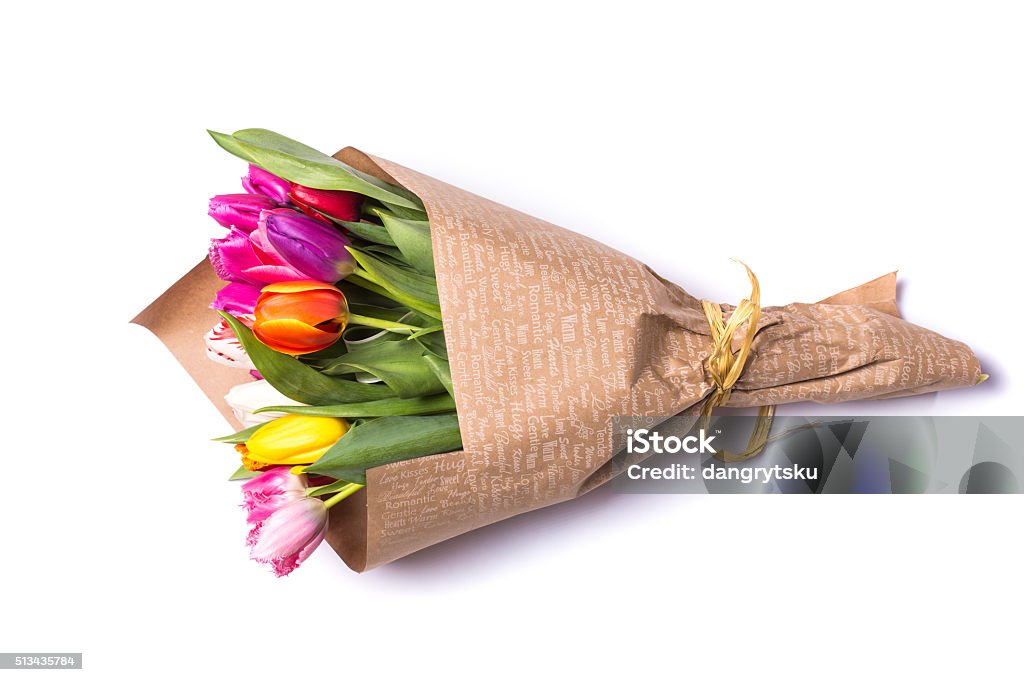 Bouquet of spring tulips flowers wrapped in gift paper Bouquet of spring tulips flowers wrapped in paper  isolated on white backgroundBouquet of spring multicolor tulips flowers wrapped in present paper  isolated on white background Bouquet Stock Photo