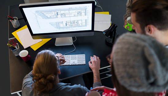 Group of young architects working in office