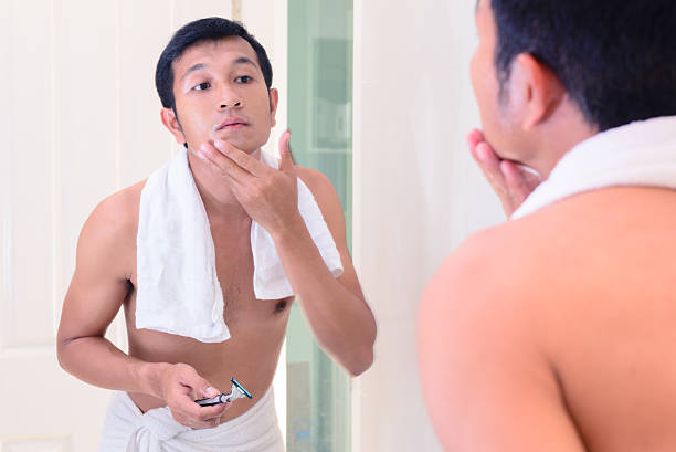 istock Young handsome man touching his smooth face after shaving. 513437516