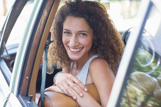 istock Woman riding in car on sunny day 513438019