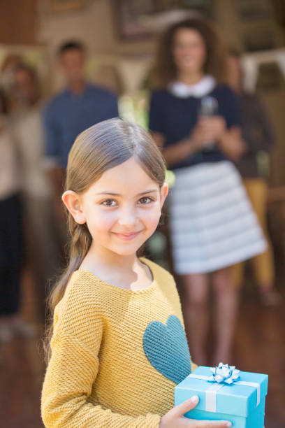 istock Young girl holding gift 513438131