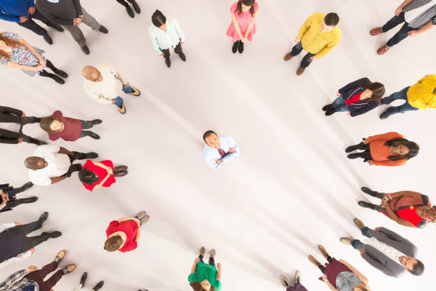 istock Crowd around businessman with arms crossed 513438253