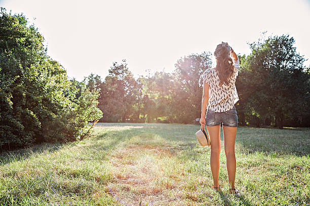istock Girl in park looking at the sun 513438294