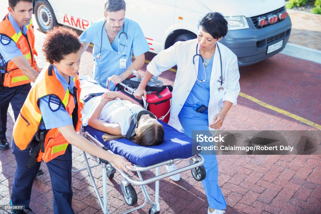 Doctor, nurse and paramedics wheeling patient on stretcher  Emergency Room Stock Photo