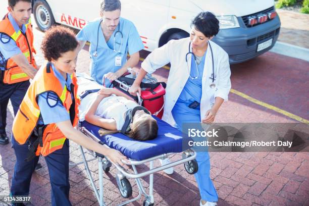 Doctor Nurse And Paramedics Wheeling Patient On Stretcher Stock Photo - Download Image Now