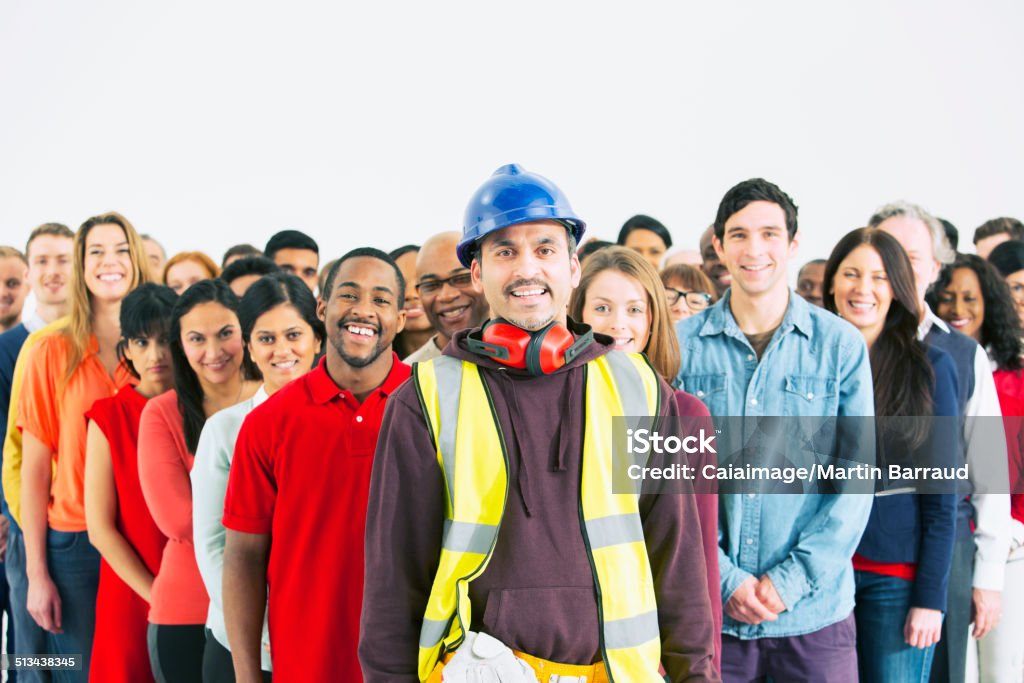 Portrait of confident construction worker and crowd  Occupation Stock Photo