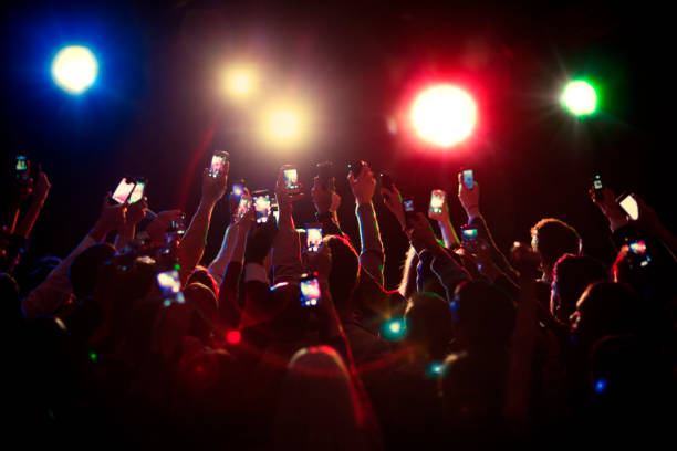 Audience using camera phones at concert  public lighting stock pictures, royalty-free photos & images
