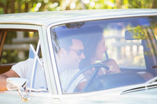istock Couple enjoying car ride on sunny day 513438467
