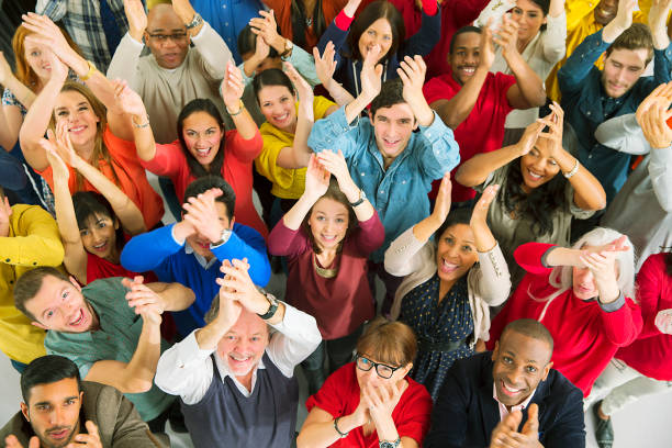 Portrait of diverse crowd clapping  large group of people facing camera stock pictures, royalty-free photos & images