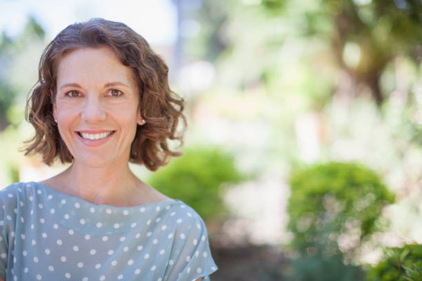 istock Older woman smiling outdoors 513438499