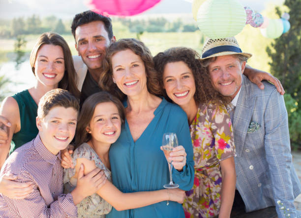 Family hugging outdoors  family reunion stock pictures, royalty-free photos & images