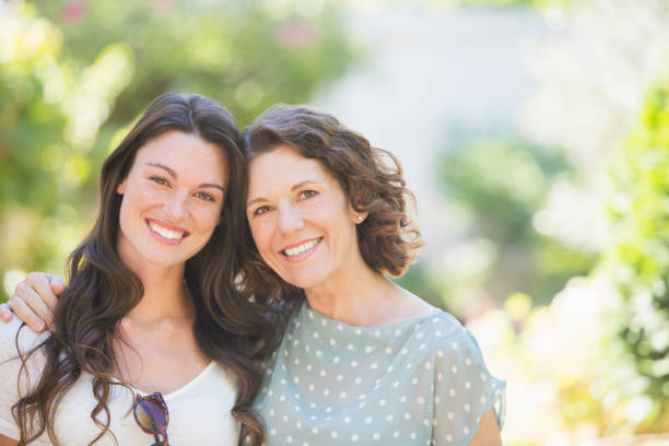 istock Mother and daughter smiling outdoors 513438721
