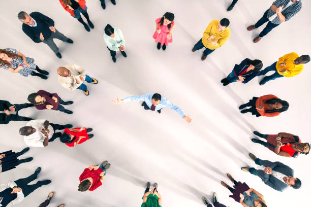 istock Crowd around businessman with arms outstretched 513438797
