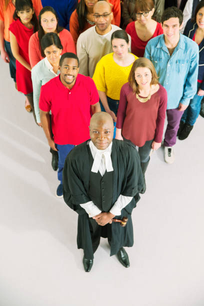istock Portrait of crowd behind confident judge 513438825