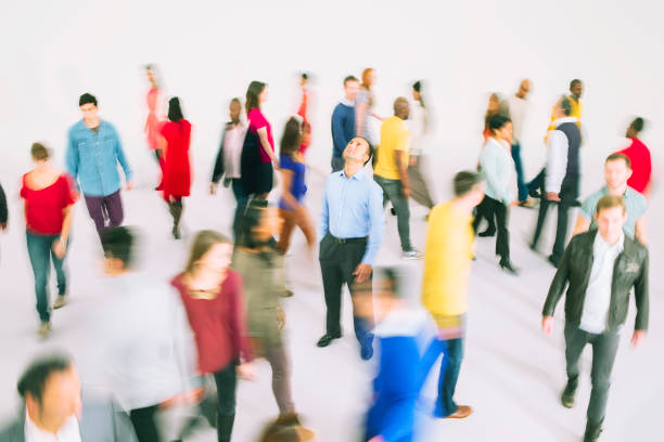 istock Businessman standing among bustling crowd 513438865