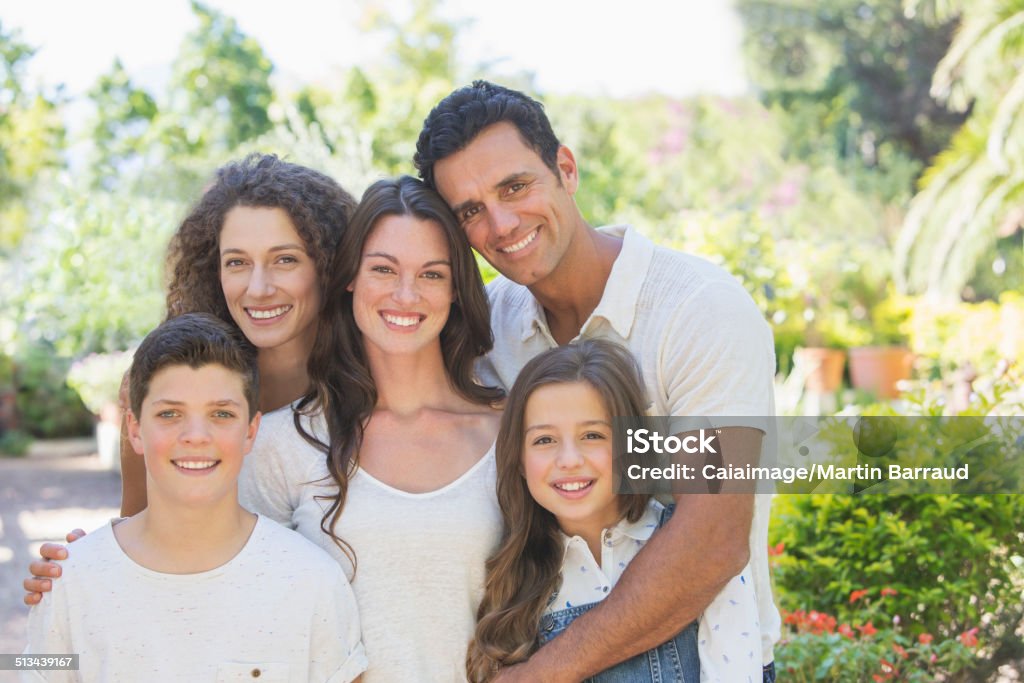 Family hugging outdoors  Teenager Stock Photo