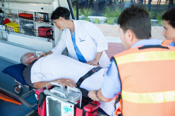 istock Doctor examining patient on ambulance stretcher 513439301