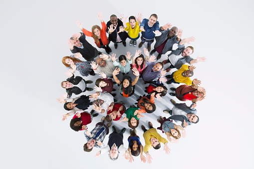 Studio portrait of a group of businesspeople posing against a gray background. Portrait of multi-ethnic male and female professionals. Business colleagues are standing against wall.