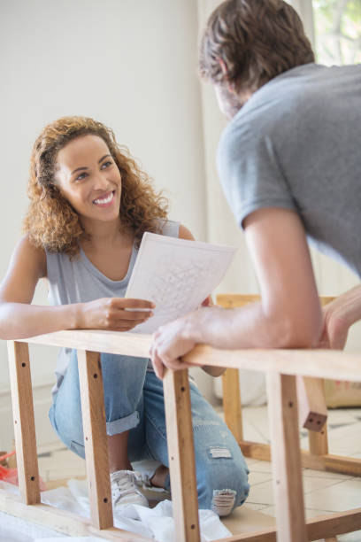 istock Couple building furniture from instructions 513439377