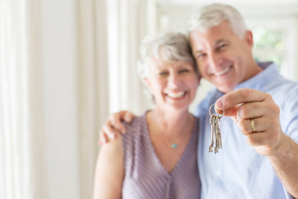 istock Older man holding keys with wife 513439411