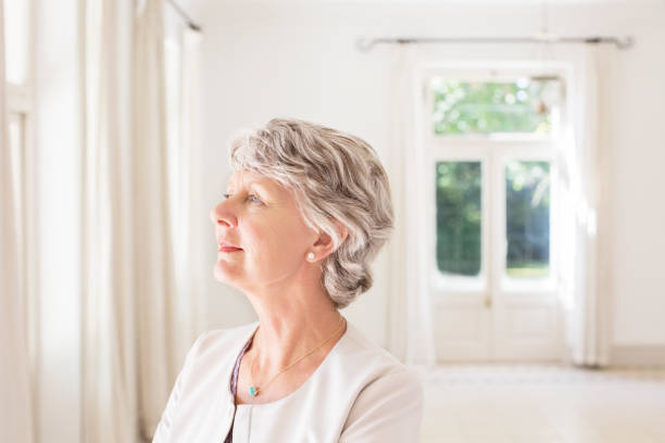 istock Older woman overlooking living space 513439457