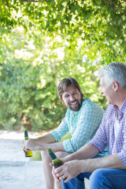 istock Father and son drinking outdoors 513439515
