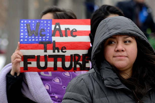 Young Mexican immigrants Madison, WI, USA- February 18, 2016 - group of people protesting new Wisconsin immigration laws dane county photos stock pictures, royalty-free photos & images