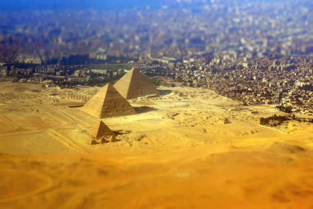 Giza Pyramid Complex seen from above El Giza, Egypt - July 21, 2011: Giza Pyramid Complex seen from above. On the foreground, the Libyan Desert, the three Great Pyramids and three small ones ("queens" pyramids). On the background, the city of El Giza. khafre photos stock pictures, royalty-free photos & images