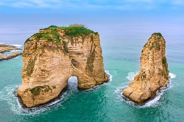Sea Landscape with Pigeons Rock Beirut Lebanon Photo of the The Pigeons' Rock rock formation and the Mediterranean Sea in Beirut, Lebanon. lebanon beirut stock pictures, royalty-free photos & images