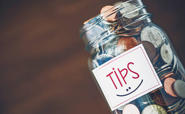 istock Tip jar with American currency on brown background 513441602