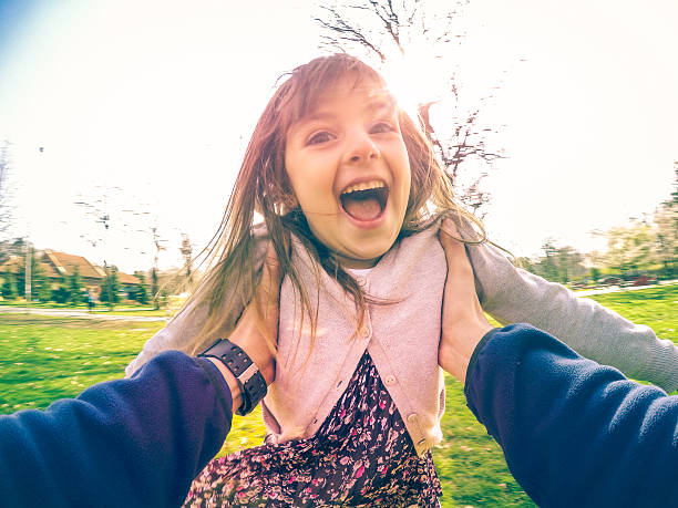 istock Father Swinging Daughter Around under Her Arms 513444770