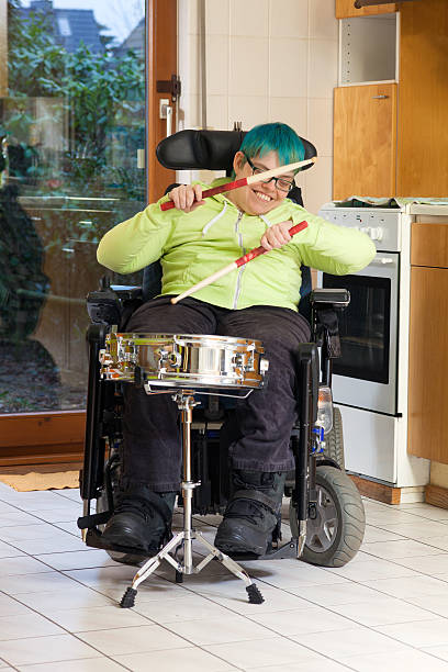 istock Young woman with cerebral palsy playing a drum. 513445115