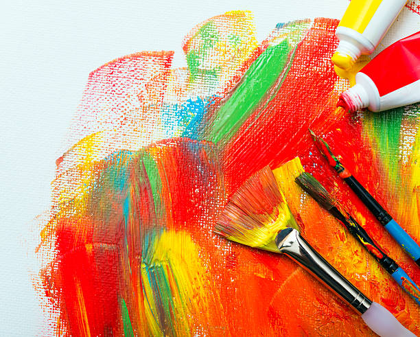 istock Paint brushes and colorfully painted canvas 513445171