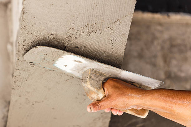 istock plasterer concrete worker at wall of house construction 513445445