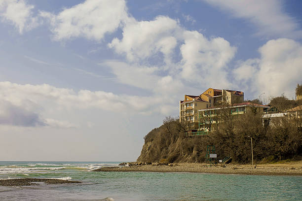 istock The rock on the coast and modern hotel at top 513445780