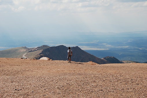 A boy admiring the view from the top of Pike's Peak, Colorado