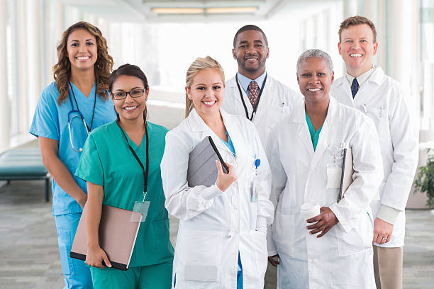 Large diverse group of hospital doctors, surgeons, and nurses Large diverse group of hospital doctors, surgeons, and nurses surgeon photos stock pictures, royalty-free photos & images