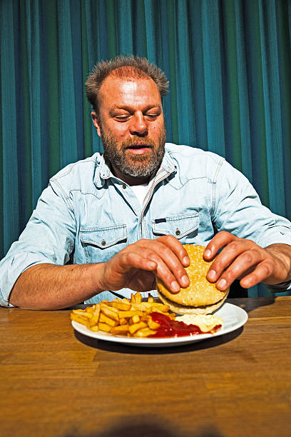 istock Man with beard eating fast food meal. 513447953
